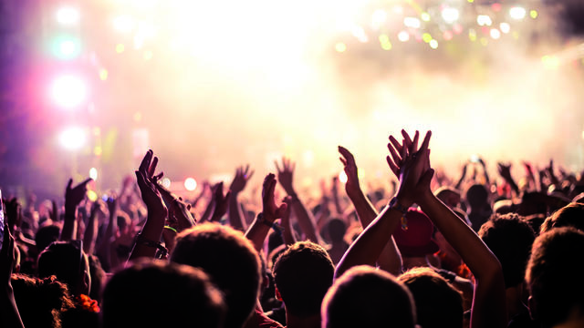 Young people cheering at a concert